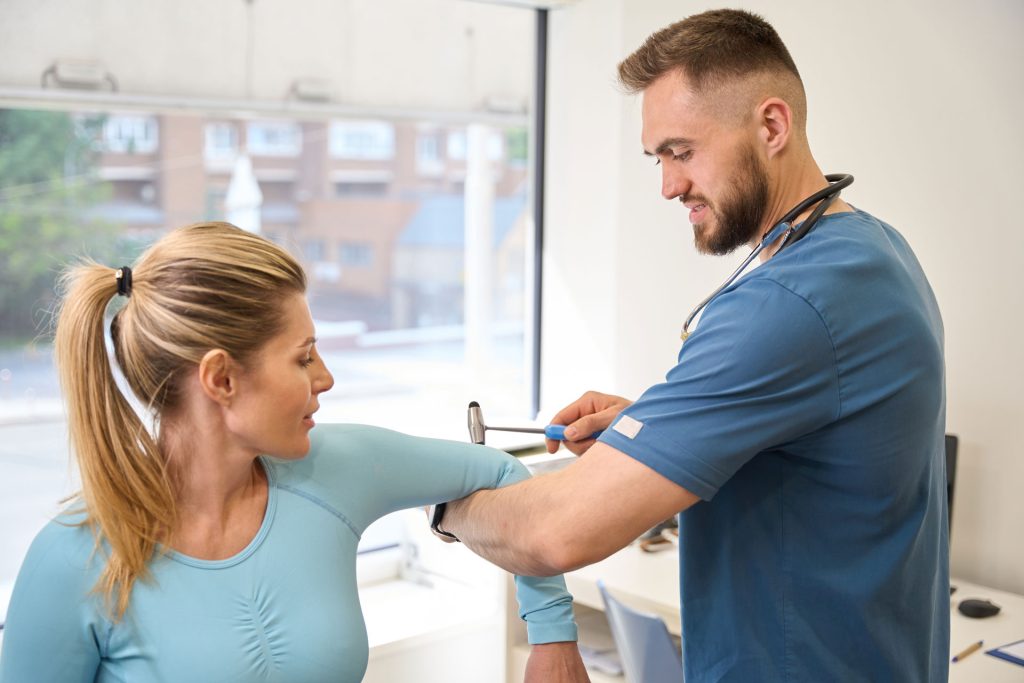 Doctor checking woman's arm.