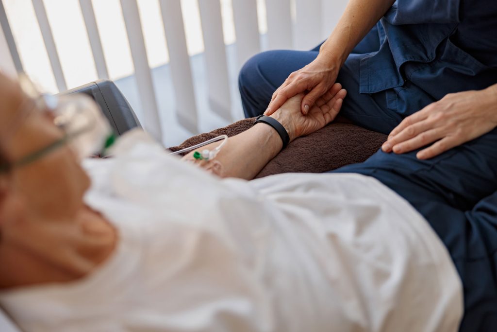 Doctor holding a patient's hand.