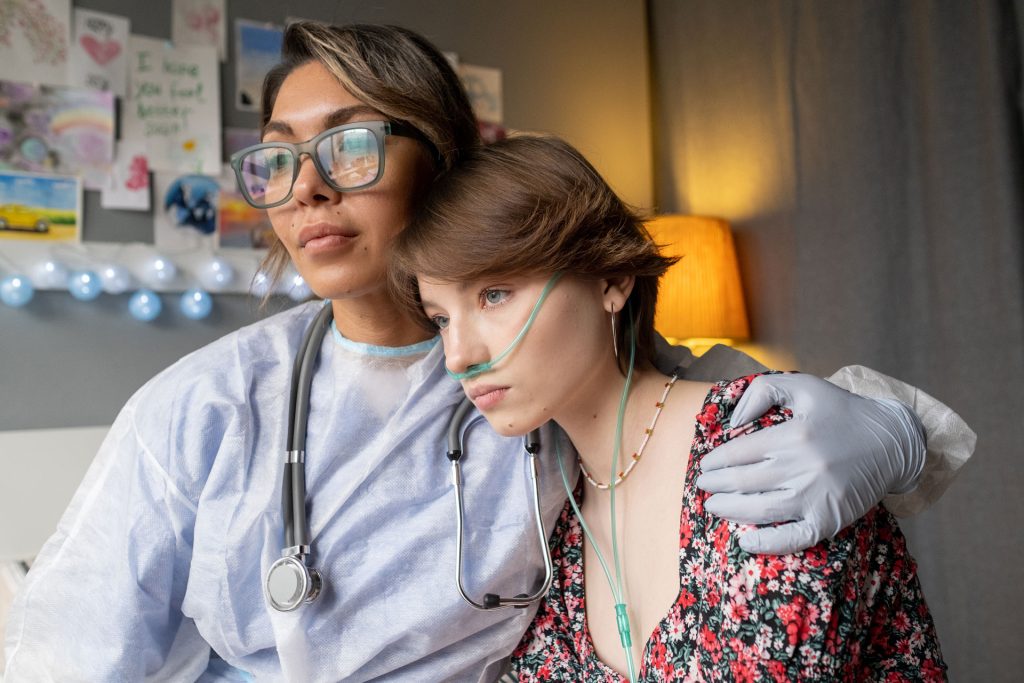 Nurse supporting a girl with acute illness.