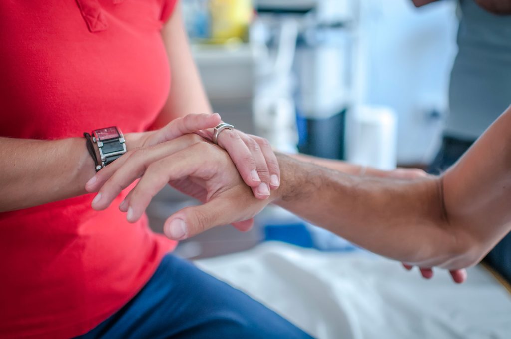 Physiotherapist applying tape after a massage.