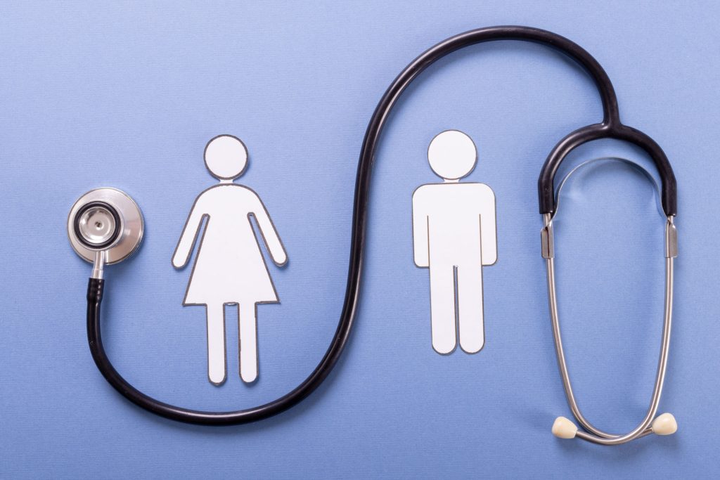 Paper couple near a stethoscope.