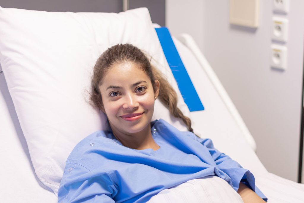Woman in hospital bed.