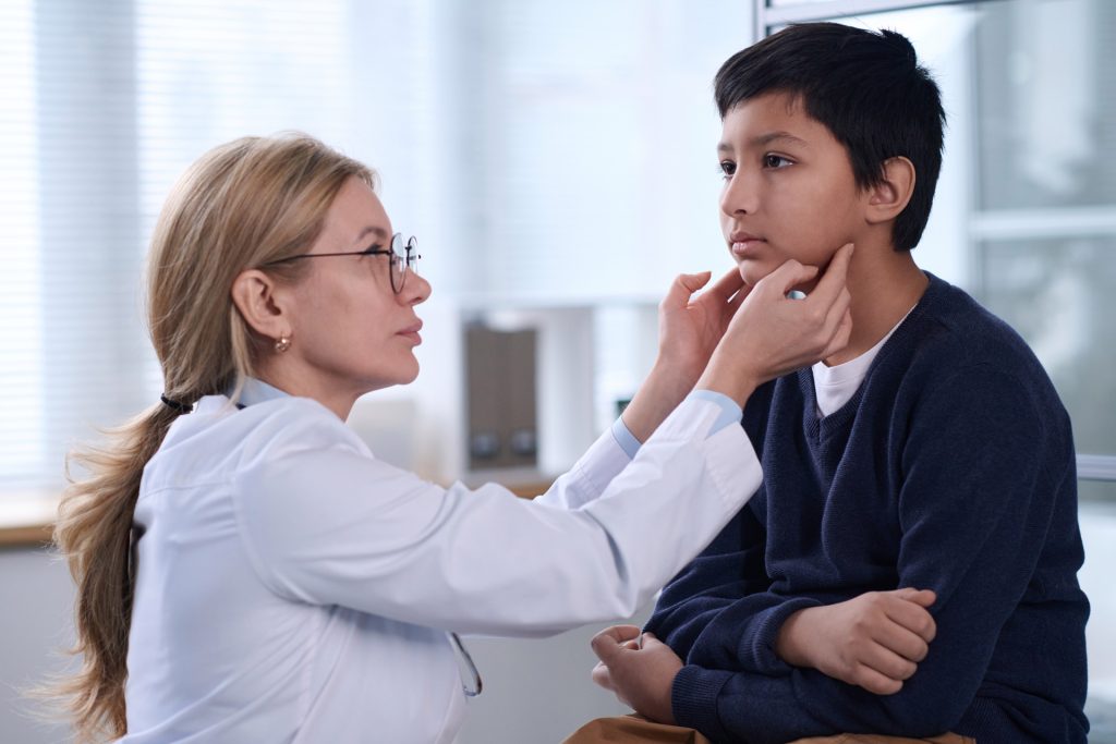 Female pediatrician examining a child patient.